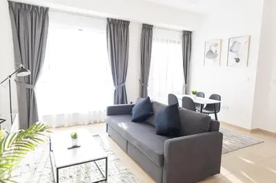 a living room with a couch and a table at Bahar JBR Apartment by HAPPY SEASON in Dubai