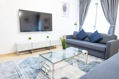 a living room with a couch and a glass coffee table at SHAMS 2 bedrooms apartment on JBR by HAPPY SEASON in Dubai