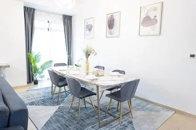 a dining room with a white table and chairs at SHAMS 2 bedrooms apartment on JBR by HAPPY SEASON in Dubai