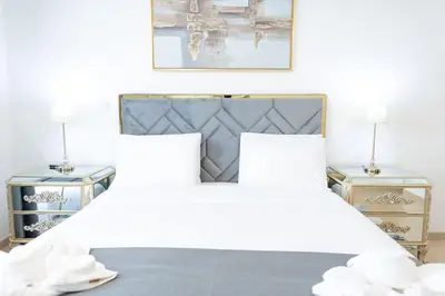 a bedroom with a large bed with two night stands at SHAMS 2 bedrooms apartment on JBR by HAPPY SEASON in Dubai