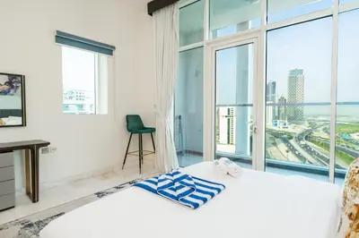 a bedroom with a bed and a large window at FAM Living - Bayz Tower by Danube - Business Bay in Dubai