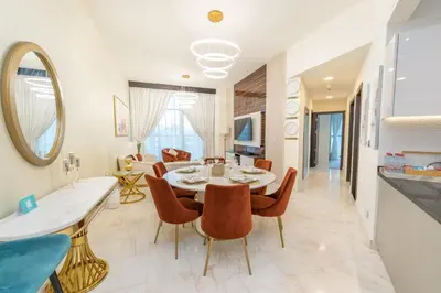 a dining room and living room with a table and chairs at FAM Living - Bayz Tower by Danube - Business Bay in Dubai