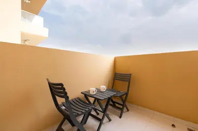 two chairs and a table with two cups on it at White Sage - Damac Ghalia JVC 35th Floor with Balcony in Dubai