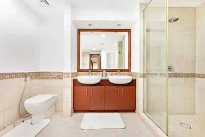 a bathroom with two sinks and a shower at StoneTree - 1BR apartment with Beach Access Fairmont in Palm Jumeirah in Dubai