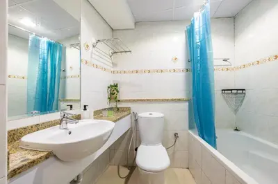 a bathroom with a sink and a toilet and a tub at Lake Terrace I JLT I 1 Bedroom Apartment in Dubai