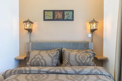a bedroom with a bed with two pillows and two lights at Lake Terrace I JLT I 1 Bedroom Apartment in Dubai