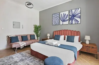 a bedroom with a large bed and a couch at StoneTree - New Cozy Studio in Dubai Marina in Dubai