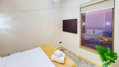 a bedroom with a bed and a window at Amazing views Dubai eye & Palm in Dubai