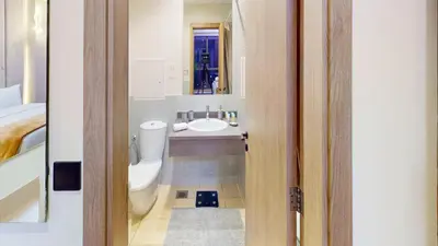 a bathroom with a sink and a toilet and a mirror at Amazing views Dubai eye & Palm in Dubai