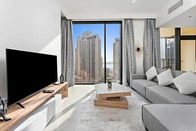 a living room with a large flat screen tv at StoneTree - Elegant 1BR in amazing community in Dubai