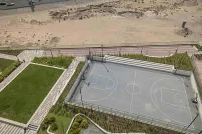 an overhead view of a basketball court in a parking lot at StoneTree - Cozy 1BR with spacious balcony in Golf Vita A in Dubai