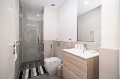 a bathroom with a toilet and a sink and a shower at StoneTree - Cozy 1BR with spacious balcony in Golf Vita A in Dubai