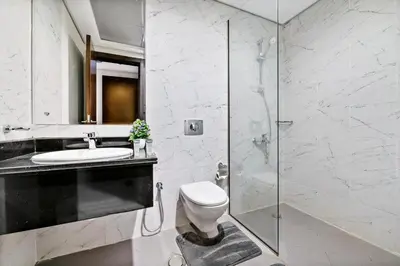 a bathroom with a shower and a toilet and a sink at StoneTree - Spacious 2BR in Peaceful Community in Dubai