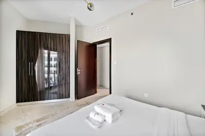 a bedroom with a bed and a large mirror at StoneTree - Spacious 2BR in Peaceful Community in Dubai