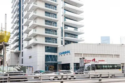a bus is parked in front of a building at Tranquil Retreat With Epic Marina View in Dubai