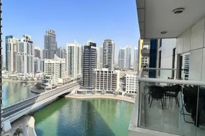 a balcony with a view of a river in a city at Tranquil Retreat With Epic Marina View in Dubai