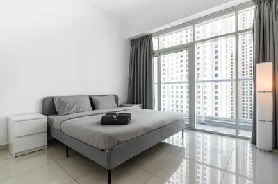 a bedroom with a bed and a large window at Tranquil Retreat With Epic Marina View in Dubai