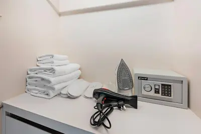a bathroom counter with towels and a microwave at StoneTree - Luxurious 1BR with Amazing Sea View in Dubai