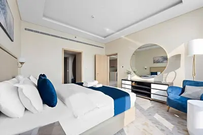 a bedroom with a large bed and a mirror at StoneTree - Luxurious 1BR with Amazing Sea View in Dubai