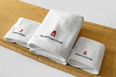 three white towels sitting on top of a table at StoneTree - Stylish 1BR & Pool with Burj Khalifa Views in Dubai