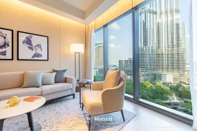 a living room with a couch and a large window at Address Opera - Lux 3 BR with Full Burj Khalifa View near Dubai Mall in Dubai