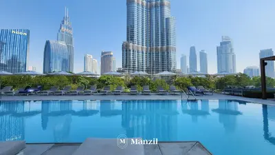 a swimming pool with a city skyline in the background at Address Opera - Lux 3 BR with Full Burj Khalifa View near Dubai Mall in Dubai