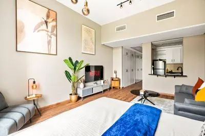 a living room with a bed and a couch at Luxury apartment at Discovery in Dubai