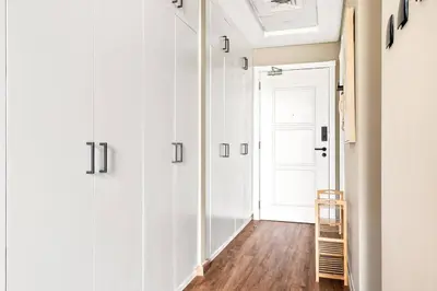 a hallway with white walls and a white door at Luxury apartment at Discovery in Dubai