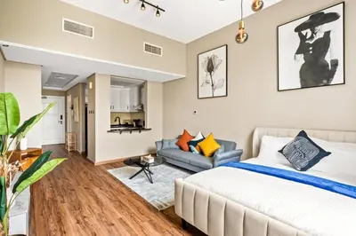 a bedroom with a bed and a couch at Luxury apartment at Discovery in Dubai