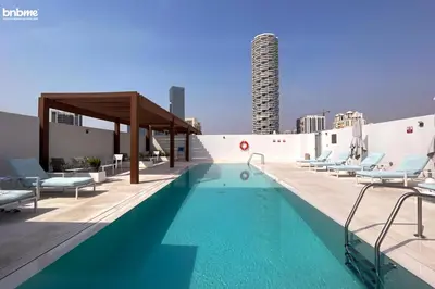 a swimming pool on the roof of a building at bnbmehomes - Luma21 in Dubai