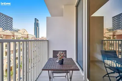 a small table on a balcony with a view of the city at bnbmehomes - Luma21 in Dubai