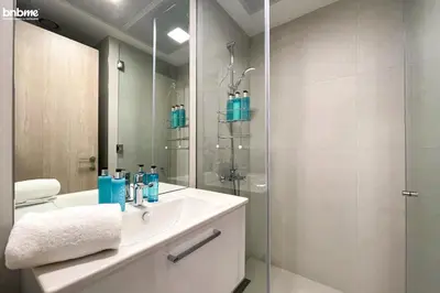 a bathroom with a sink and a glass shower at bnbmehomes - Luma21 in Dubai