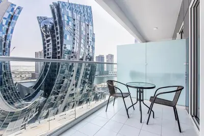 a balcony with a table and chairs and a large window at New 1 bedroom with Canal View - Close to Downtown in Dubai