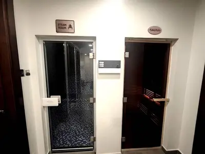 a bathroom with a walk in shower next to a glass door at New 1 bedroom with Canal View - Close to Downtown in Dubai