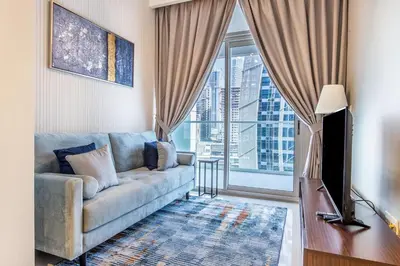 a living room with a couch and a large window at New 1 bedroom with Canal View - Close to Downtown in Dubai
