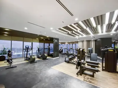 a gym with treadmills and ellipticals in a building at StoneTree - Furnished 2 BR with City View in Dubai