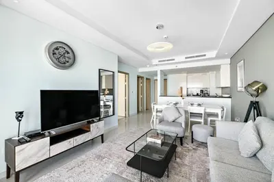 a living room with a large flat screen tv at StoneTree - Furnished 2 BR with City View in Dubai