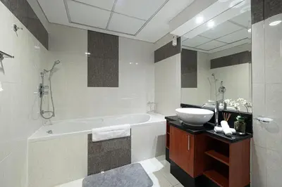a bathroom with a bath tub and a sink at DIFC Luxurious Spacious 1-Bed Apt in a Prime Location in Dubai