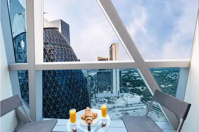 a table with two chairs and two candles on top of a building at DIFC Luxurious Spacious 1-Bed Apt in a Prime Location in Dubai