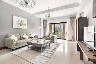 a living room with a couch and a table at StoneTree - Luxurious 1 BR with Beach Access at Fairmont The Palm in Dubai