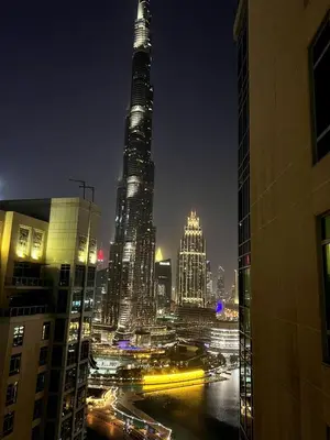 a view of a city at night with tall buildings at INA HOMES - 2BHK Residences Tower 1 in Dubai