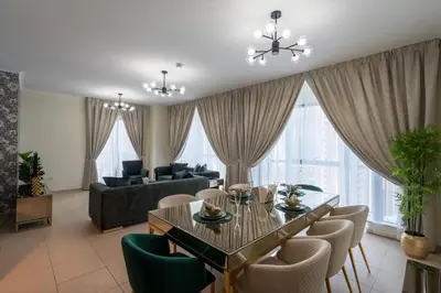 a living room with a dining table and chairs at INA HOMES - 2BHK Residences Tower 1 in Dubai
