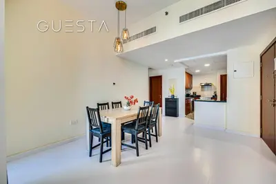 a dining room and kitchen with a table and chairs at Jumeirah Beach Residence - Rimal 4, Dubai Marina in Dubai