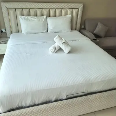 a stuffed animal is sitting on a bed at 7 Palm Jumeirah in Dubai