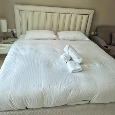 a white bed with towels on top of it at 7 Palm Jumeirah in Dubai