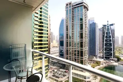 a balcony with a view of a city at StoneTree - Furnished Studio with Lake View and near Metro in Dubai