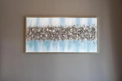 a picture frame hanging on a wall at Coastal Bay 1 Bedroom in Dubai