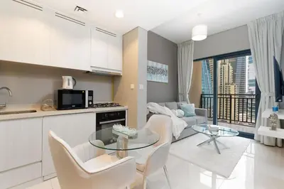 a kitchen and living room with a table and chairs at Coastal Bay 1 Bedroom in Dubai