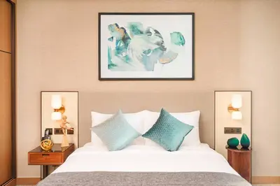 a bedroom with a bed with blue and white pillows at Prime Retreats @ Address Residence Opera By Emaar in Dubai