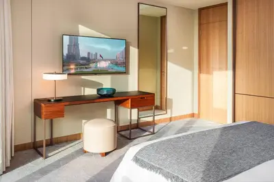 a bedroom with a bed and a desk with a television at Prime Retreats @ Address Residence Opera By Emaar in Dubai